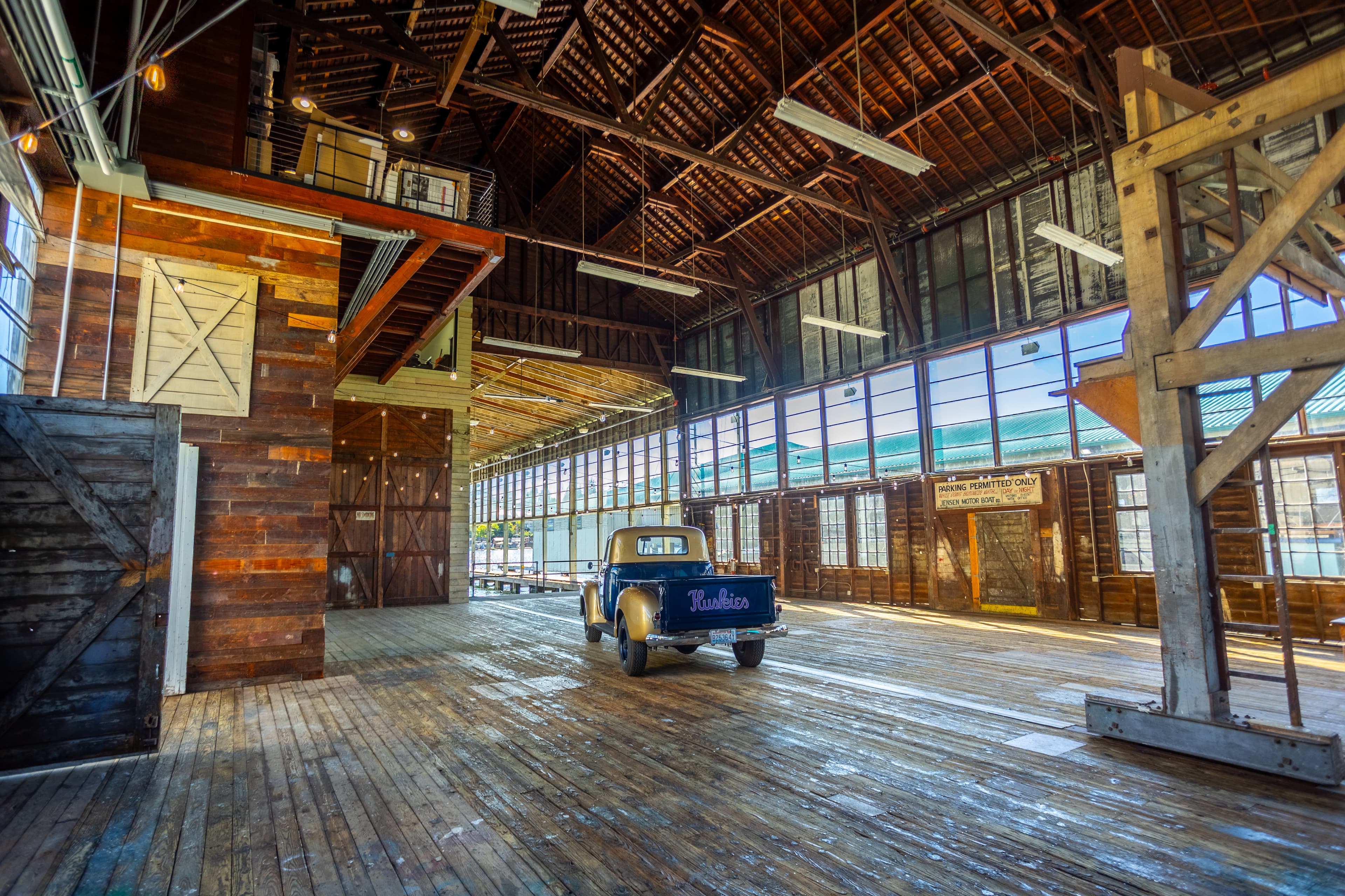 Morning light in the empty boat barn with the vintage truck on the deck